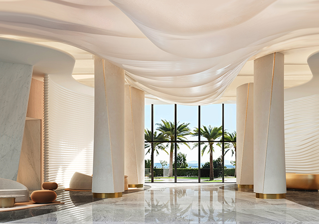 In the lobby, sculpted walls and sweeping curves guide visitors through the space, with the design echoing the desert and sea.
